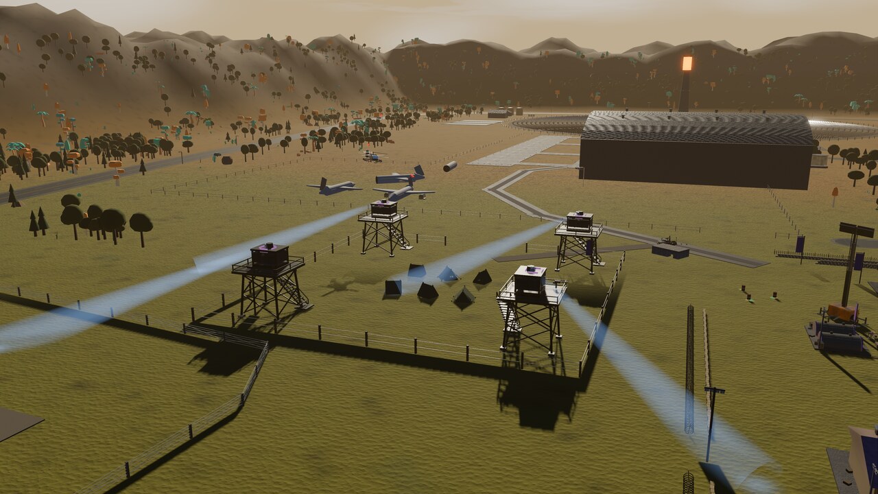 The POW pen: locked tents inside the wire, searchlight towers sweeping