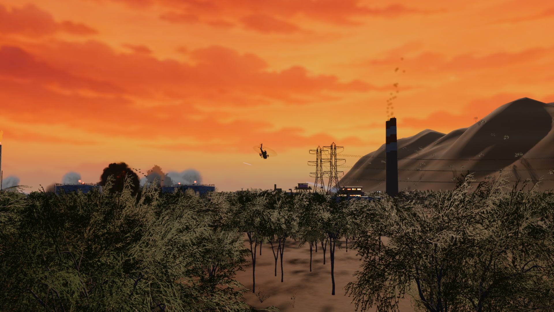 A gunship banking away from the burning refinery at dusk