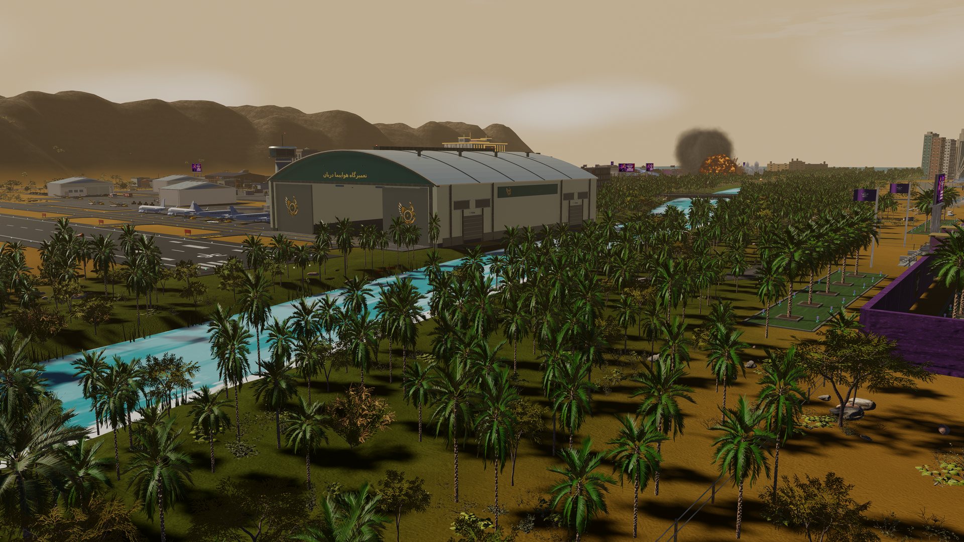 The boneyard hangar beyond a palm grove and the river